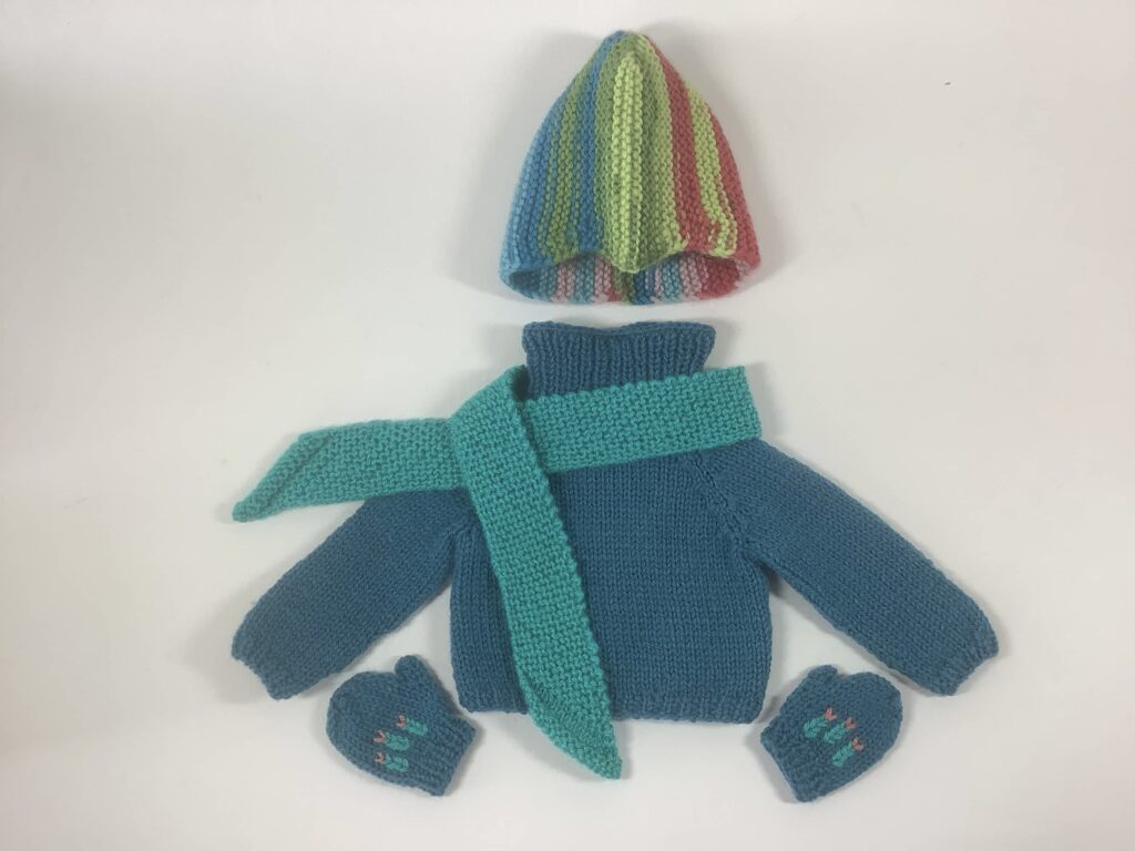 knit blue sweater/scarf/hat/mitts